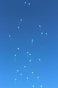 color balloons flying away to the sky