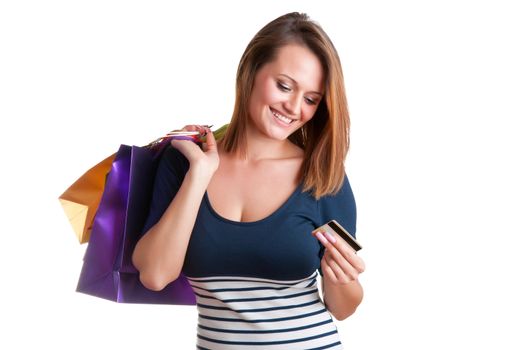 Woman Carrying Shopping Bags and holding a credit card isolated in a white background