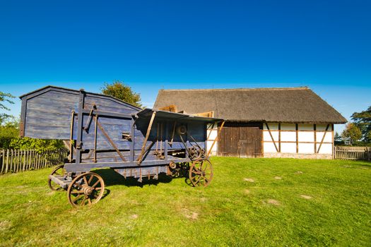 Old rural barn in polish heritage park and threshing-machine - XIXth century