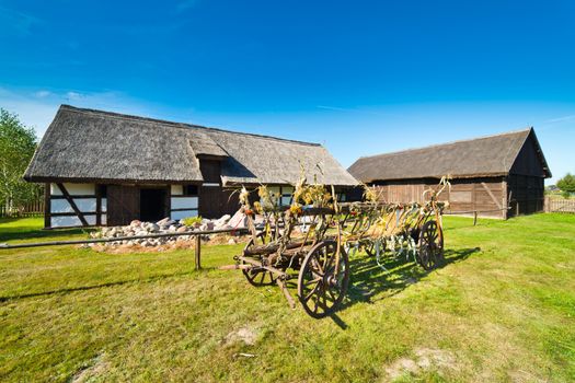 Old rural barn in polish heritage park and threshing-machine - XIXth century