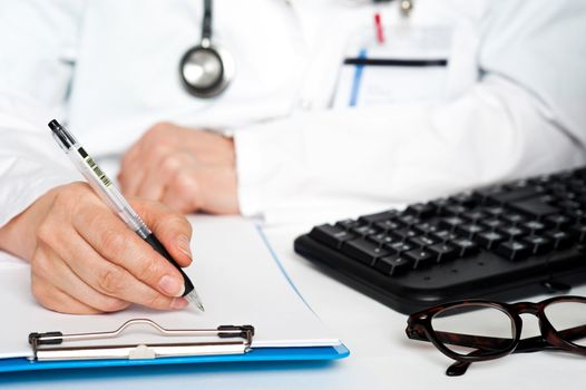 Physician writing prescription-cropped image