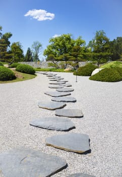 Stone's way in the Japanese garden in sunny day