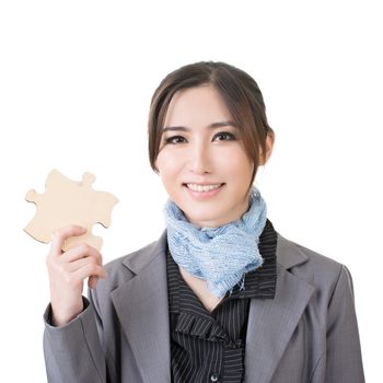 Asian business woman hold a wooden puzzle, closeup portrait on white background.