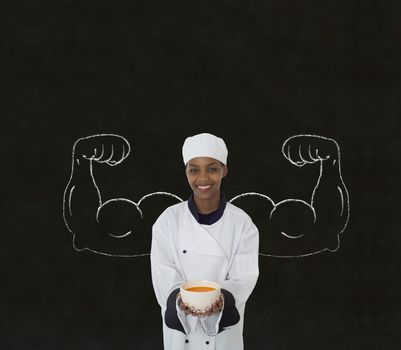African American woman chef with chalk healthy strong arms on blackboard background