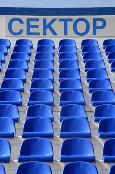  inscription: "Sector"  in the stadium  with blue chairs