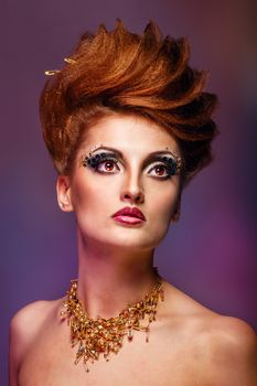 Close-up portrait of a young and attractive girl with hairstyle and jewelry