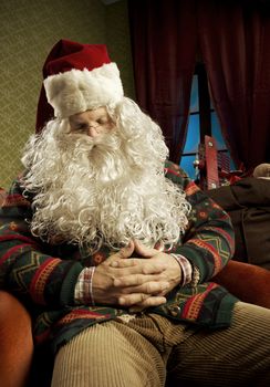 Portrait of Santa Claus sleeping on armchair