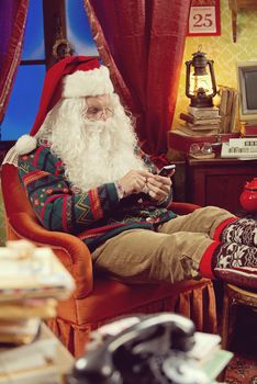 Portrait of Santa Claus using his new smartphone 