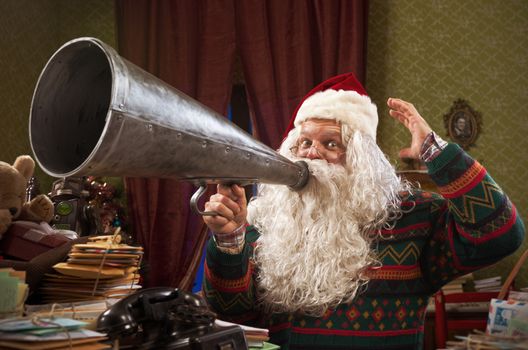 SantaClaus shouting into a vintage megaphone