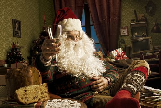 Portrait of Santa Claus celebrating with a glass of champagne