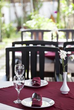 Restaurant table with plates and  spoon and fork sets