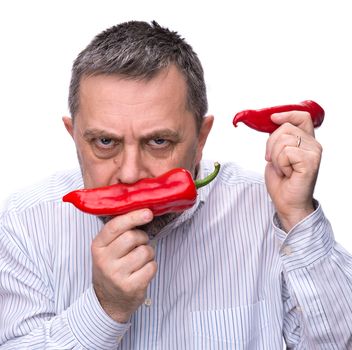 Organic food. Joy of vegetarianism. A man with a red pepper. Isolated on white