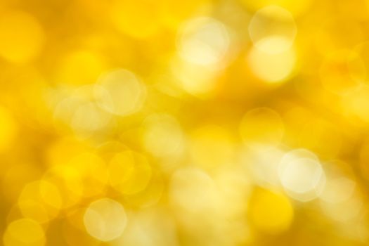 Golden festive abstraction. Defocus highlights. yellow background