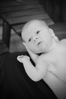 baby being held in black and white
