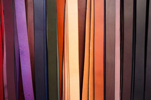 Colorful leather belts on a market stall