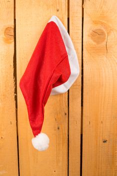 Santa Clauss hat pinned on a wooden door