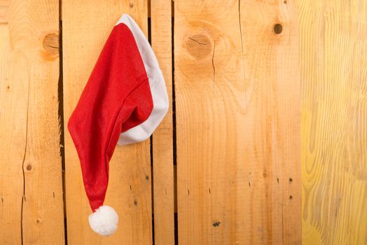 Santa Clauss hat pinned on a wooden door