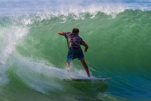 Surfer surfing trim in pocket of good wave