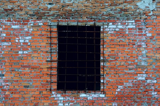 An old wall made from bricks with a window