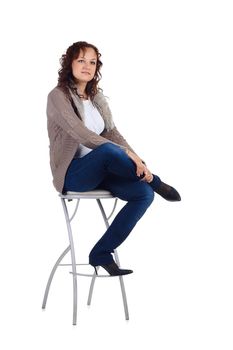 Girl sitting on the bar chair at white background