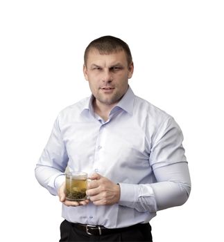 A tired man with a glass of green tea in hand on white background