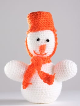 White snowman made from threads at the grey background