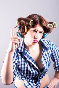 portrait of sexy housewife with curlers