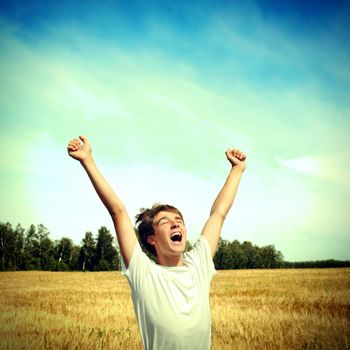 Toned photo of Happy Teenager in the Wheat Field
