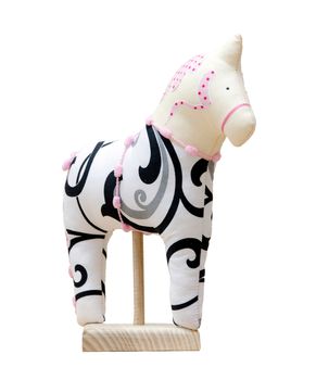 The Hand made soft toy horse isolated on white with pink on the stand