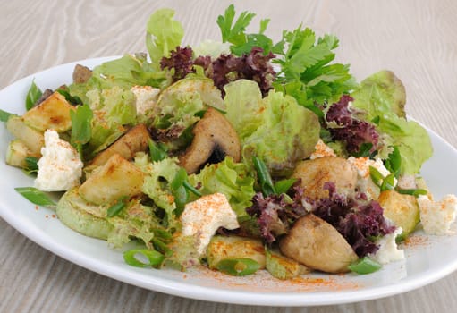 baked mushrooms and zucchini in lettuce leaves under red peppers and cheese
