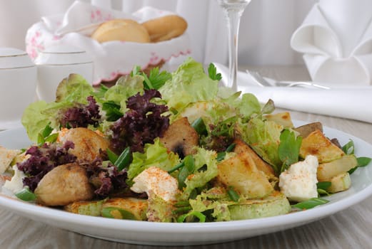 Salad with mushrooms with zucchini, cheese in lettuce leaves and red pepper