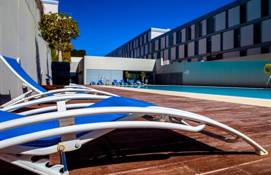Several deckchairs near the swimming pool