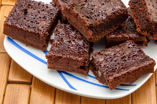 Composition of a pile of chocolate brownies on a plate
