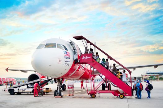 Kuala Lumpur, Malaysia -  May 14, 2013: Boarding on AirAsia  Jet airplane in Kuala Lumpur airport . AirAsia been named as the world's best low-cost airline, operates scheduled domestic and international flights to 78 destinations spanning 25 countries