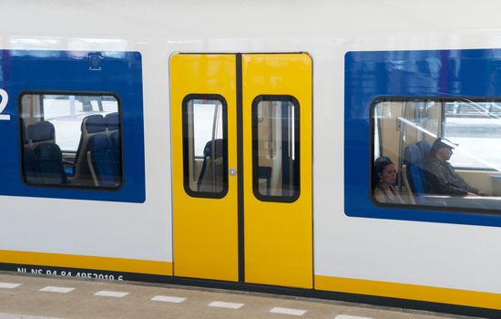 people in holland in train waiting for transport