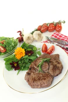 a roasted ribeye steak with wild herb salad