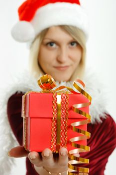 Beautiful girl in Santa hat with a gift