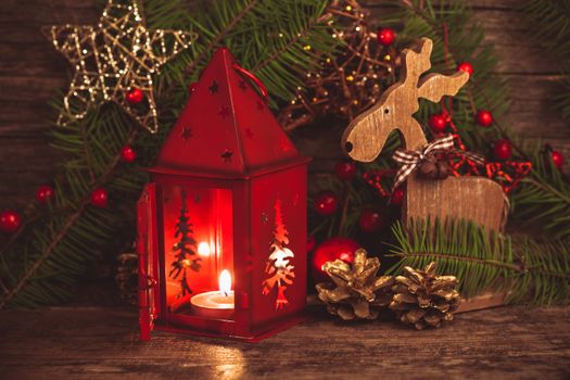 Red christmas candlestick over holiday decorations on the table