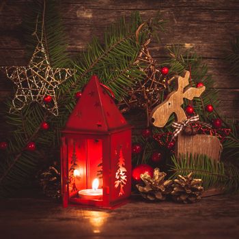 Red christmas candlestick over holiday decorations on the table