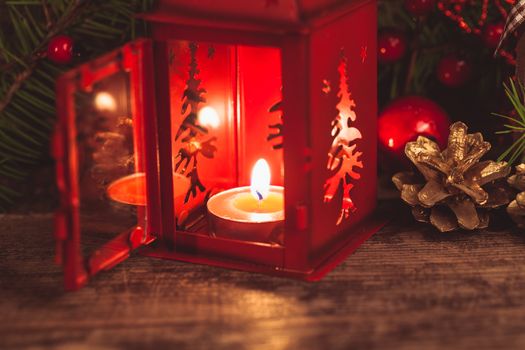 Red christmas candlestick over holiday decorations on the table