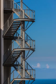 Steel stairway steps back of building for fire escape.