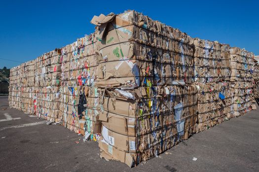 Cardboard paper packed strapped and packed in stacks for recycling pulp.