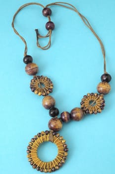 Handmade Wood Collar Necklace on a Colored Background