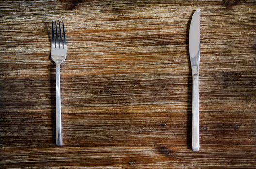 Knife and fork set on a wooden vintage table