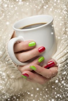 Woman in Sweater with Seasonal Red and Green Nail Polish Holding a Warm Cup of Coffee with Snow Flakes Border.