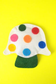 Cloth Multicolored Magic Mushroom on a Colored Background