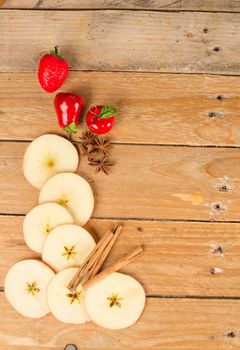 Sliced apples in a still life with cinnamon sticks