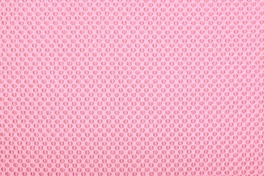 Pink fabric with dots, a textile background.