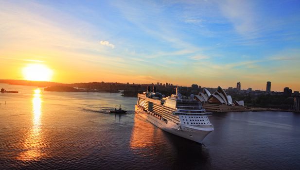 Sydney, Australia - November 28, 2013:  Celebrity Solstice, one of Australia's highest rated superliners sails into Sydney Harbour Circular Quay at sunrise. Focus to ship