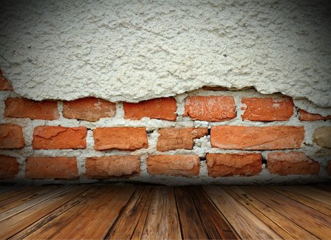 grungy cracked brick wall and old wooden floor on interior architectural background